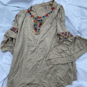 Tan/cream 3/4 sleeve top. Embroidery on neckline